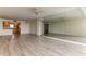 Living room with hardwood floors, large mirror, and kitchen view at 5130 Brittany S Dr # 408, St Petersburg, FL 33715