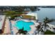 Aerial view of resort-style pool with surrounding lounge chairs and waterfront access at 5130 Brittany S Dr # 408, St Petersburg, FL 33715