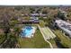 Aerial view of the community pool and shuffleboard courts, surrounded by lush landscaping at 1442 Normandy Park Dr # 1, Clearwater, FL 33756