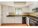 White kitchen cabinets, stainless steel appliances, and tile floor at 1442 Normandy Park Dr # 1, Clearwater, FL 33756