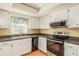 Clean kitchen featuring white cabinets and tile floors at 1442 Normandy Park Dr # 1, Clearwater, FL 33756