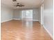 Spacious living room featuring laminate flooring and a sliding glass door leading to outdoor living space at 1442 Normandy Park Dr # 1, Clearwater, FL 33756