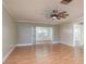Comfortable living room with a ceiling fan and sliding glass doors open to a sunroom at 1442 Normandy Park Dr # 1, Clearwater, FL 33756