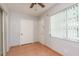 Relaxing sunroom offering natural light, tiled floors, and a ceiling fan for added comfort at 1442 Normandy Park Dr # 1, Clearwater, FL 33756