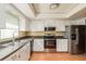 Bright kitchen with white cabinets, stainless steel appliances, and tile floor at 1442 Normandy Park Dr # 1, Clearwater, FL 33756