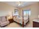 Cozy bedroom with a four-poster bed, an upholstered chair, and plenty of natural light at 3503 10Th W Ln, Palmetto, FL 34221