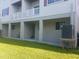 Back of building with patios, gray support beams, and stairwell leading up to second floor at 3503 10Th W Ln, Palmetto, FL 34221