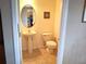 Traditional half bath with pedestal sink, toilet, and decorative mirror at 3503 10Th W Ln, Palmetto, FL 34221