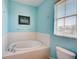 Bathroom with garden tub, toilet, and light blue walls at 3503 10Th W Ln, Palmetto, FL 34221