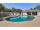Relaxing kidney-shaped pool with lounge chairs and shaded area at 3503 10Th W Ln, Palmetto, FL 34221