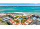 Aerial view of waterfront community with pool and beach access at 855 Bayway Blvd # 101, Clearwater, FL 33767