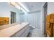 Bright bathroom featuring a long vanity with ample counter space, a large mirror, and a shower with a curtain at 4136 Rhone Dr, New Port Richey, FL 34655