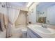 Bathroom featuring a tub with shower, white fixtures, and a vanity with ample counter space at 4136 Rhone Dr, New Port Richey, FL 34655