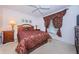 Comfortable bedroom features patterned bedding and a bright ceiling fan at 4136 Rhone Dr, New Port Richey, FL 34655