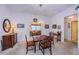 Cozy dining room with carpet, wood table set, and decorative floral accents at 4136 Rhone Dr, New Port Richey, FL 34655
