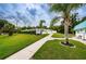 Inviting pool entrance with lush landscaping and clear signage at 4136 Rhone Dr, New Port Richey, FL 34655