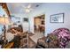 Cozy sitting room with a daybed, patterned armchair, and a view into the adjacent dining and kitchen areas at 4136 Rhone Dr, New Port Richey, FL 34655