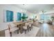 Open concept dining area with a wood table and access to living room at 12305 3Rd E St # 2, Treasure Island, FL 33706