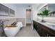Spa-like bathroom featuring a freestanding tub and double vanity at 12305 3Rd E St # 2, Treasure Island, FL 33706