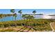 Aerial view of waterfront property showing lush landscaping and a relaxing walkway at 755 Collany Rd # 401, Tierra Verde, FL 33715