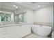 Modern bathroom featuring a freestanding soaking tub, double vanity, and a large shower at 755 Collany Rd # 401, Tierra Verde, FL 33715