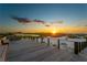 Wooden deck overlooking a tranquil beach at sunset at 755 Collany Rd # 401, Tierra Verde, FL 33715