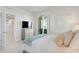 Bedroom with large TV, dresser, and access to hallway at 755 Collany Rd # 401, Tierra Verde, FL 33715