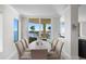 Bright dining room features water views and a large dining table with seating for eight at 755 Collany Rd # 401, Tierra Verde, FL 33715