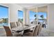 Elegant dining room with water views and seating for six at 755 Collany Rd # 401, Tierra Verde, FL 33715