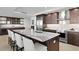 Gourmet kitchen features dark wood cabinetry, expansive island with marble countertop, and high-end appliances at 755 Collany Rd # 401, Tierra Verde, FL 33715