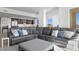 Spacious living room with sectional sofa and view of kitchen with modern appliances at 755 Collany Rd # 401, Tierra Verde, FL 33715