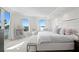 Bright and airy primary bedroom features a king-size bed and stunning water views at 755 Collany Rd # 401, Tierra Verde, FL 33715