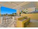 Outdoor kitchen with granite countertops and stainless steel appliances at 755 Collany Rd # 401, Tierra Verde, FL 33715