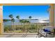 Stunning water view from balcony, featuring a relaxing chair and scenic waterfront landscape at 755 Collany Rd # 401, Tierra Verde, FL 33715