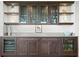 Built-in wet bar with glass-front cabinetry, wine cooler, and ample storage at 755 Collany Rd # 401, Tierra Verde, FL 33715