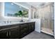 Modern bathroom featuring a double vanity and large mirror at 12305 3Rd E St # 3, Treasure Island, FL 33706