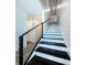 Modern staircase with dark wood steps and metal railing at 12305 3Rd E St # 3, Treasure Island, FL 33706
