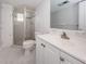 Bathroom with a white vanity, toilet, and tiled shower with glass doors at 1868 Shore S Dr # 410, South Pasadena, FL 33707