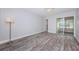 Bedroom featuring beautiful flooring, a floor lamp, and access to a screened in patio at 1868 Shore S Dr # 410, South Pasadena, FL 33707
