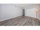 Spacious bedroom featuring wood-look floors, ceiling fan, and closet with sliding doors at 1868 Shore S Dr # 410, South Pasadena, FL 33707