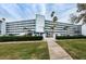 Attractive exterior of a mid-rise condo building showcasing its architecture and well-maintained landscaping at 1868 Shore S Dr # 410, South Pasadena, FL 33707