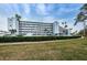 Beautiful condo building with lush landscaping and ample parking for residents and guests at 1868 Shore S Dr # 410, South Pasadena, FL 33707