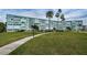 Well-maintained building exterior with lush landscaping and manicured lawn at 1868 Shore S Dr # 410, South Pasadena, FL 33707