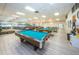 Spacious game room with pool tables, ping pong, and lounge seating for residents' enjoyment at 1868 Shore S Dr # 410, South Pasadena, FL 33707