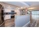 Modern kitchen with stainless appliances, granite countertops, a breakfast bar, and wood-look flooring at 1868 Shore S Dr # 410, South Pasadena, FL 33707