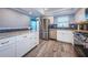 Modern kitchen features stainless appliances, granite counters, and blue tile backsplash at 1868 Shore S Dr # 410, South Pasadena, FL 33707