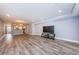 Open living space with wood-look floors, easy access to the kitchen, and a covered outdoor space at 1868 Shore S Dr # 410, South Pasadena, FL 33707
