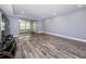 Open concept living area featuring wood-look flooring, and sliding glass door access to the screened porch at 1868 Shore S Dr # 410, South Pasadena, FL 33707