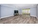 Living room with beautiful flooring, light-blue colored walls, and access to a screened in patio at 1868 Shore S Dr # 410, South Pasadena, FL 33707