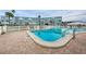 Inviting community pool with clear blue water, steps, and nearby buildings at 1868 Shore S Dr # 410, South Pasadena, FL 33707